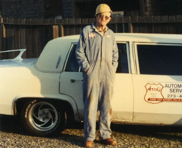 Arch Brooks in front of company car.