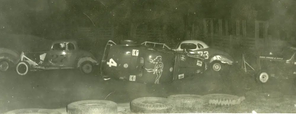 Auto race, car number 4 turned on its side with Arch’s Automitive Sponsorship all over it.